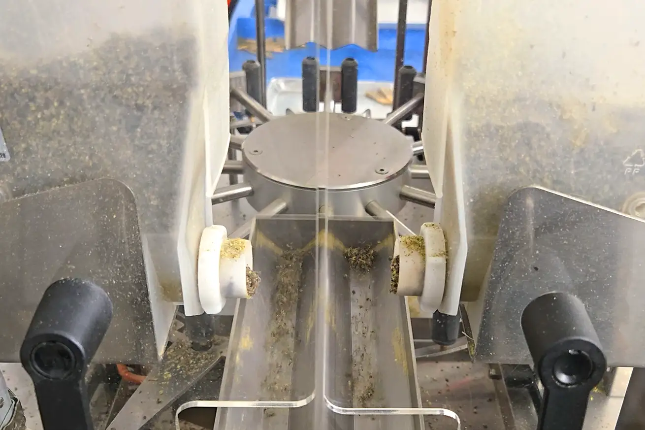 cannabis canisters in a rolling machine